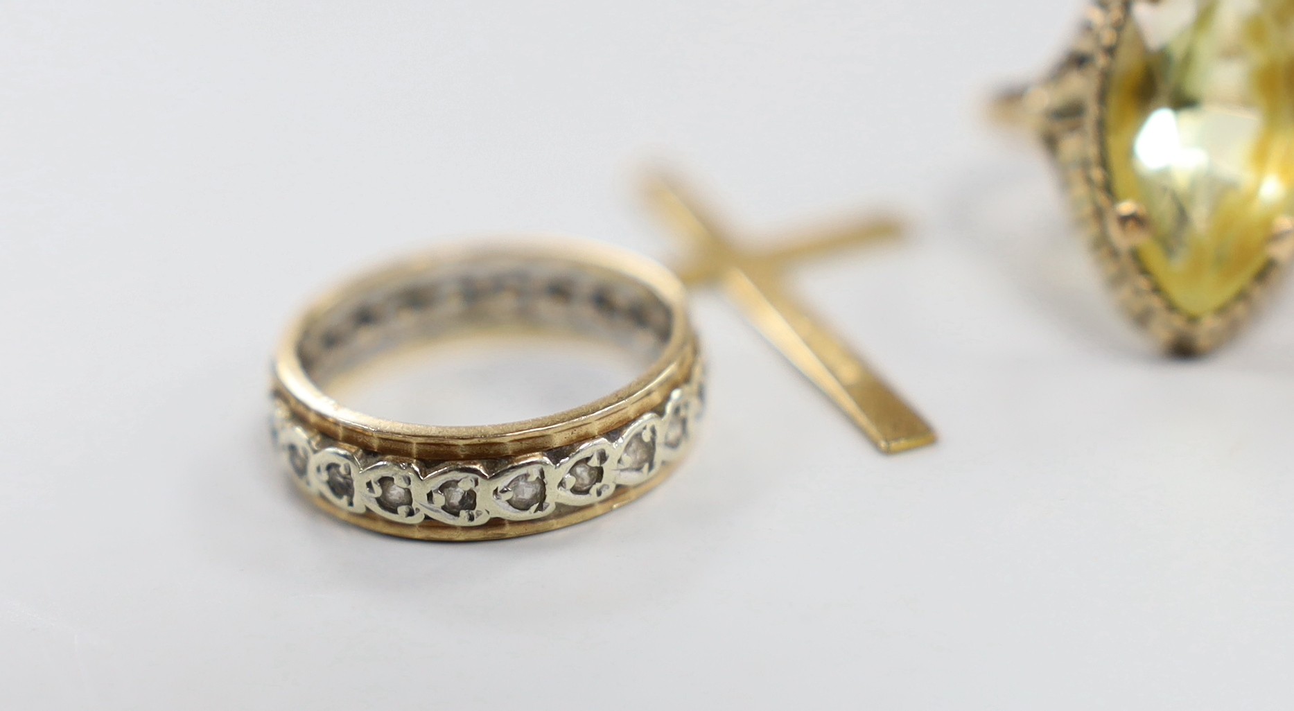 Three 9ct gold and gem set rings, gross 13.4 grams, a 9ct gold cross and one other yellow metal ring.